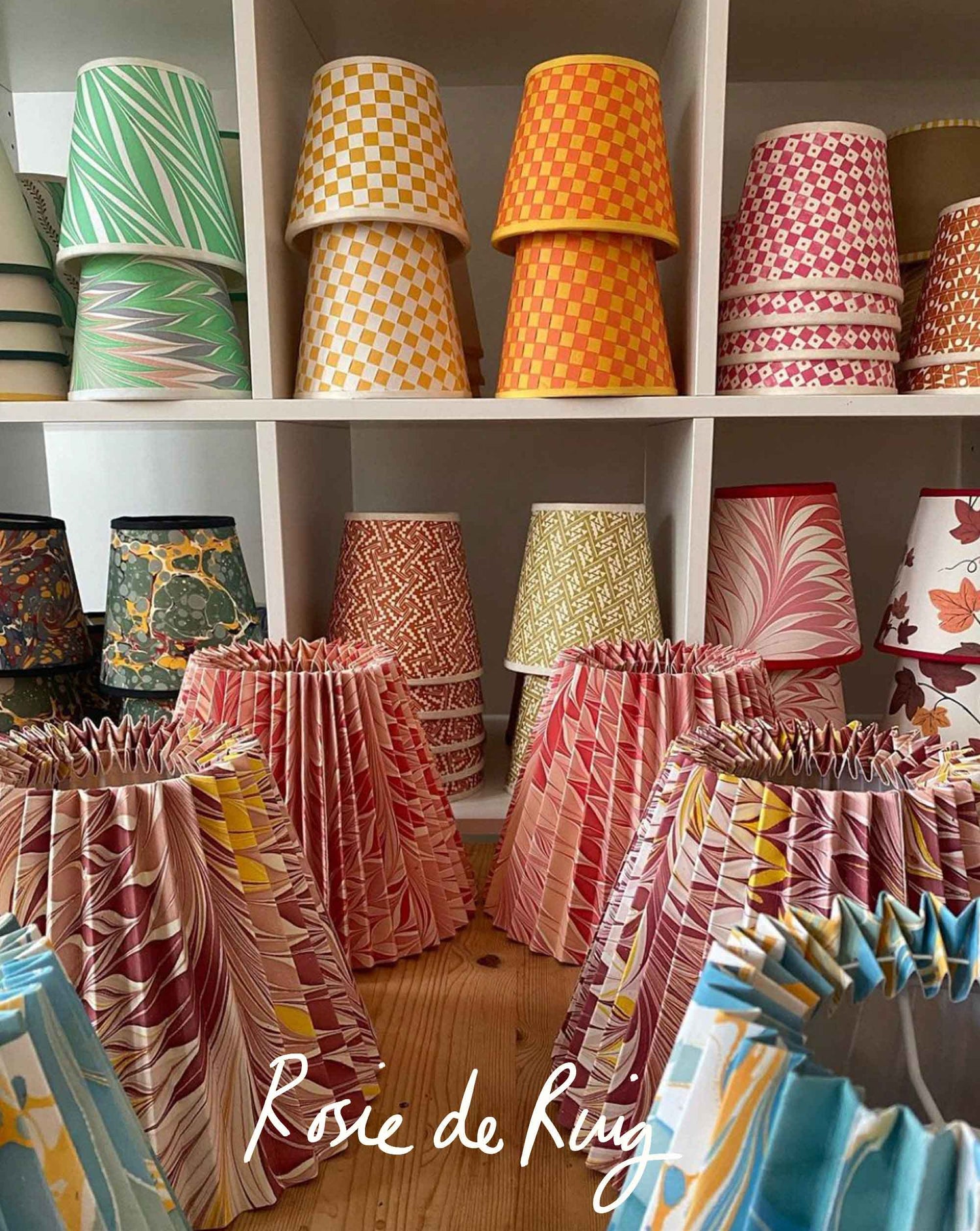 Rosi de Ruig studio of lampshades on shelves and floor